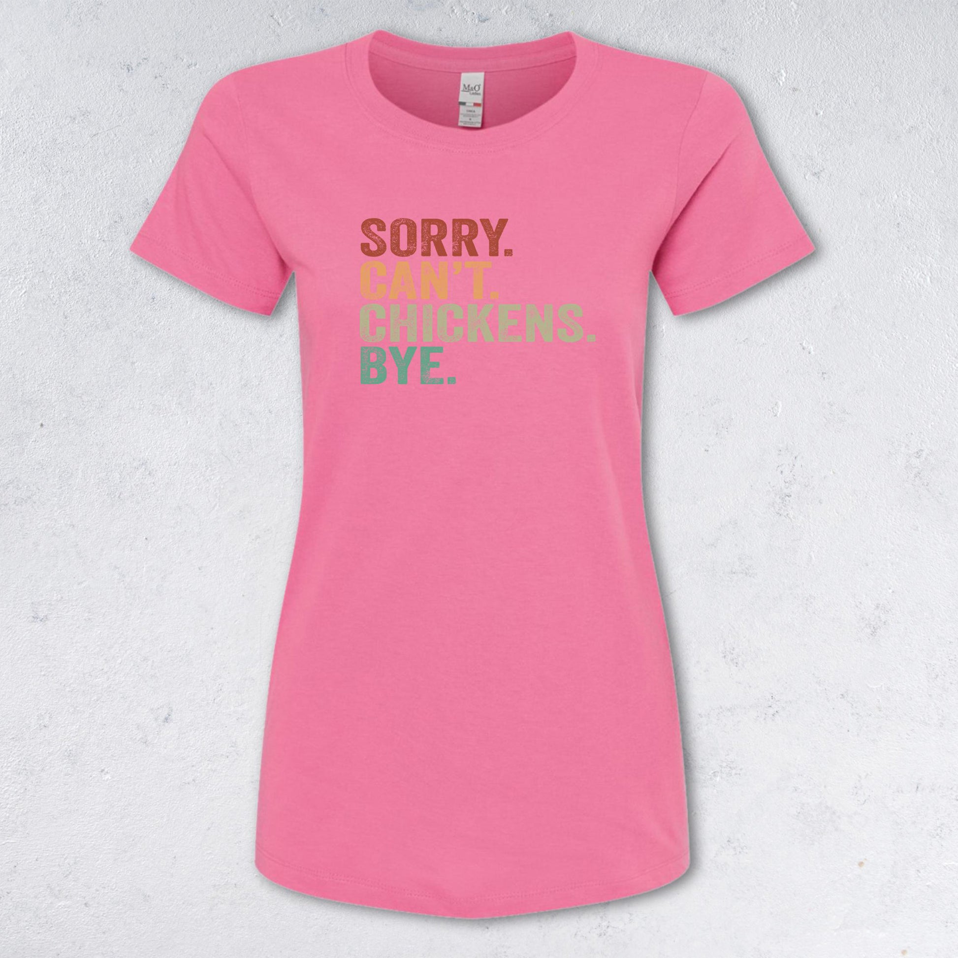 Pink t-shirt with humorous text design on a textured white background