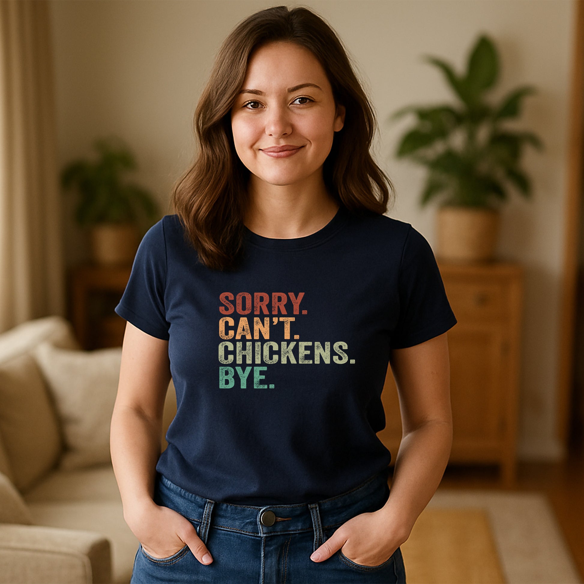 Woman wearing a navy blue t-shirt with colorful text in a living room.