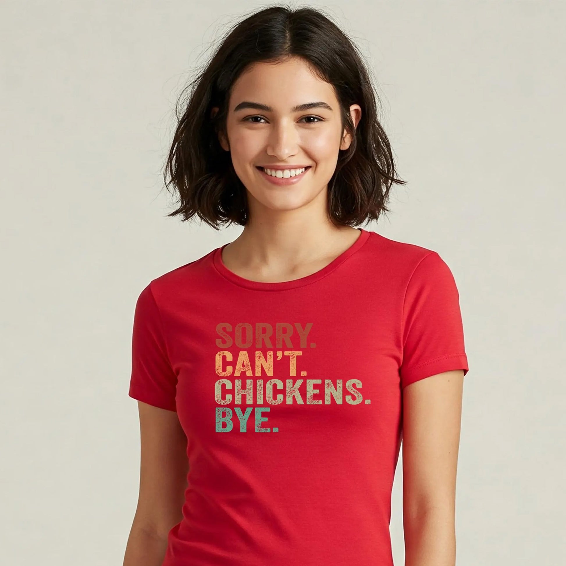 Person wearing a red t-shirt with a humorous message on a plain background
