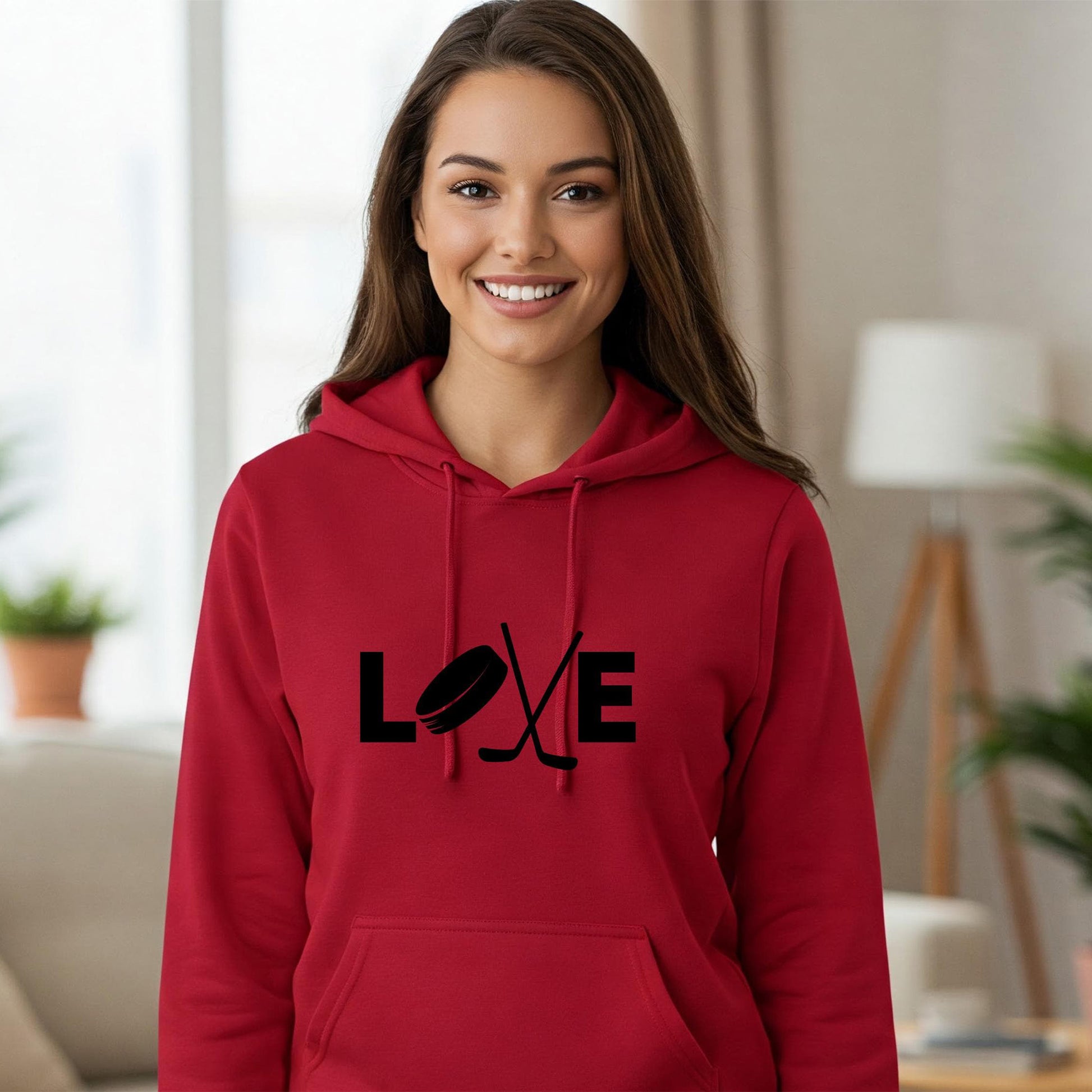 Woman wearing a red hoodie with 'LOVE' printed on it in a living room setting