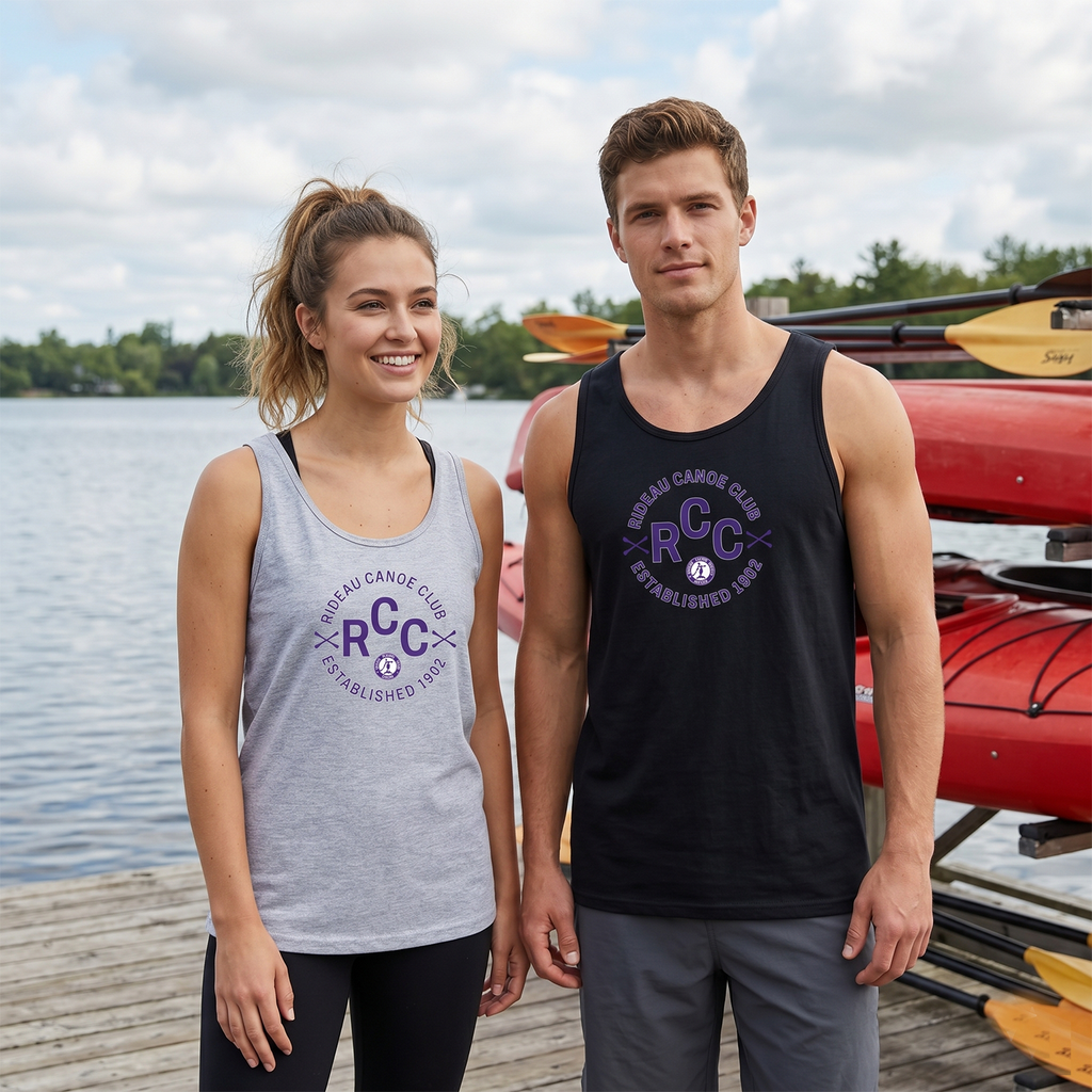Two people wearing tank tops with 'RCC' logos by a lake with kayaks.