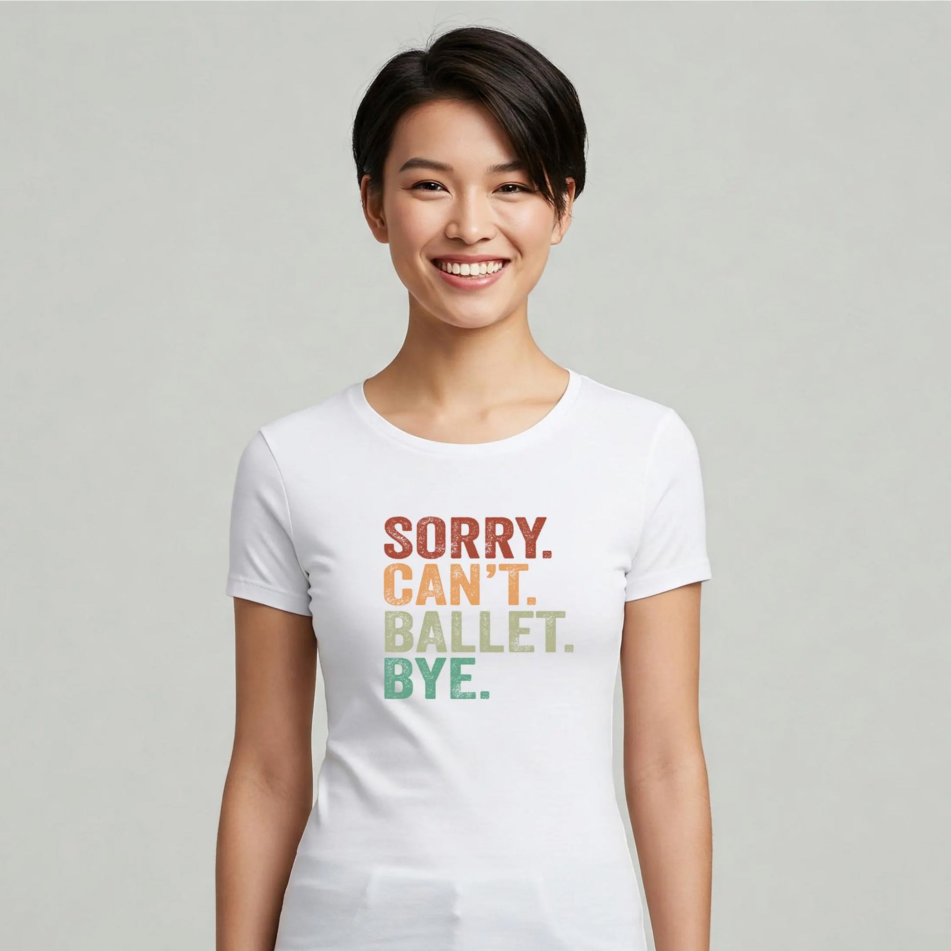 Person wearing a white t-shirt with colorful text on a plain background