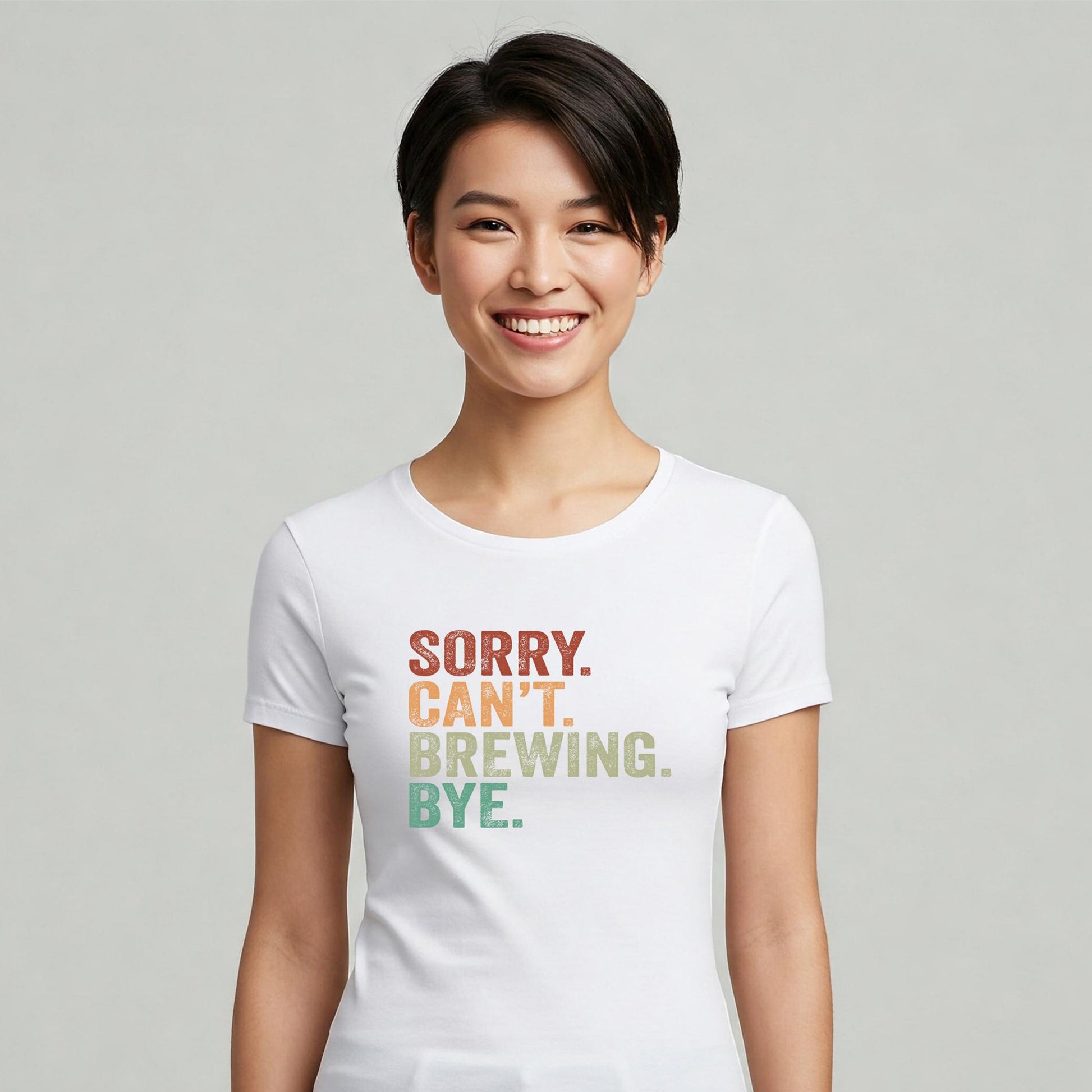 Person wearing a white t-shirt with colorful text on a plain background
