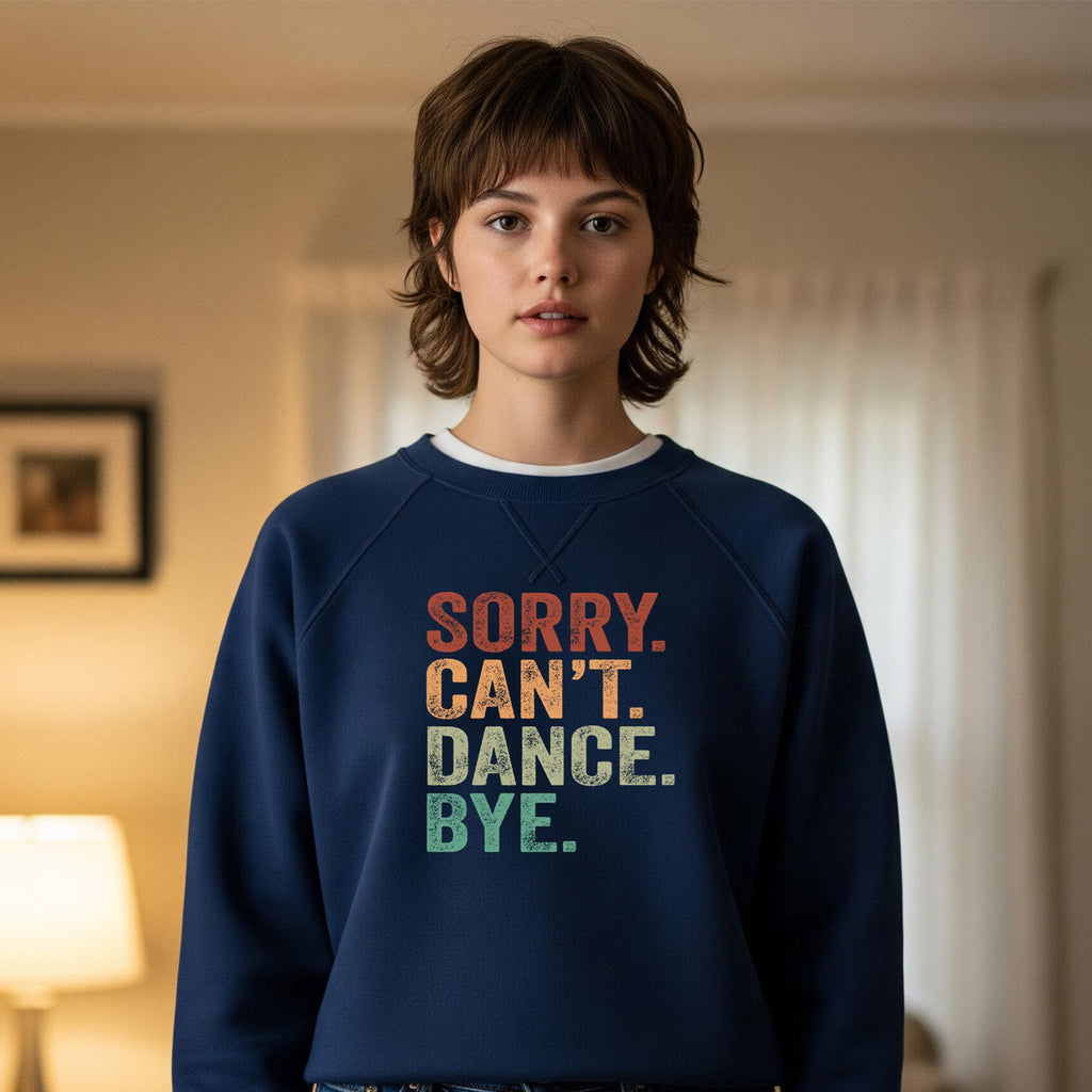 Person wearing a navy blue sweatshirt with colorful text in a room.