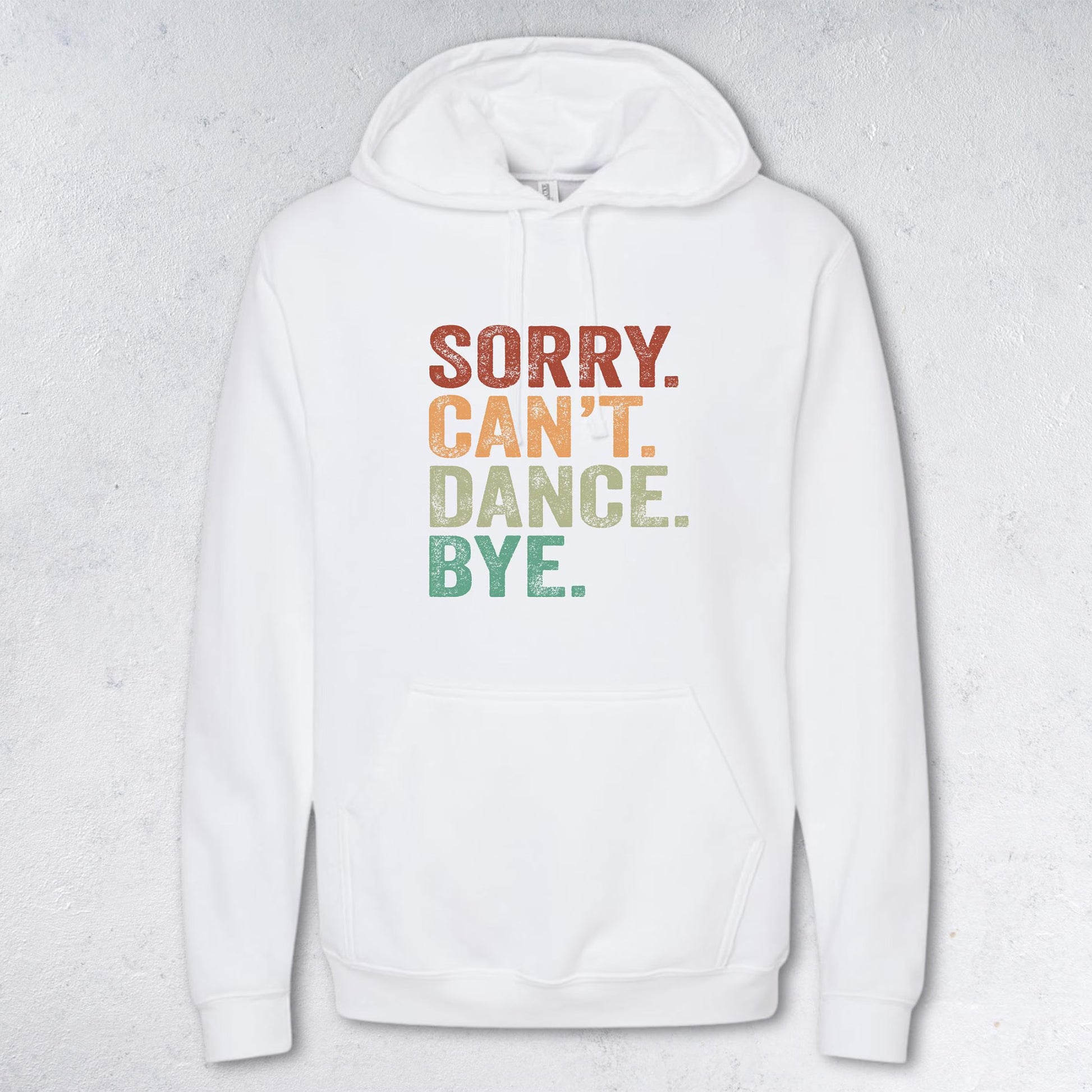 White hoodie with colorful text 'SORRY. CAN'T. DANCE. BYE.' on a light gray background