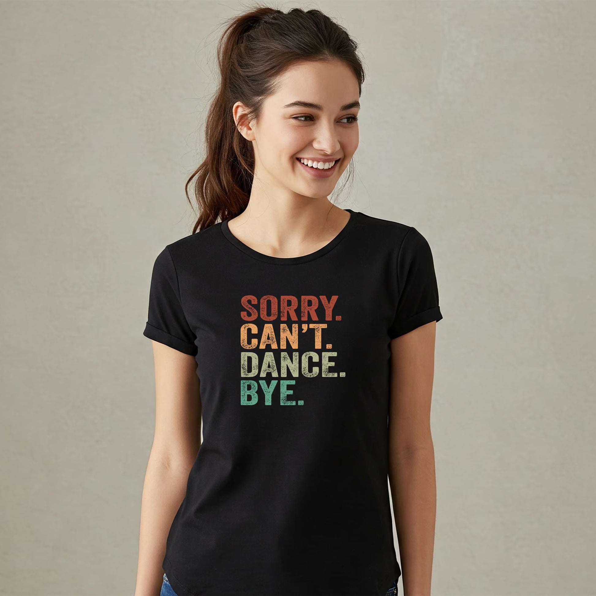 Woman wearing a black t-shirt with colorful text on a plain background