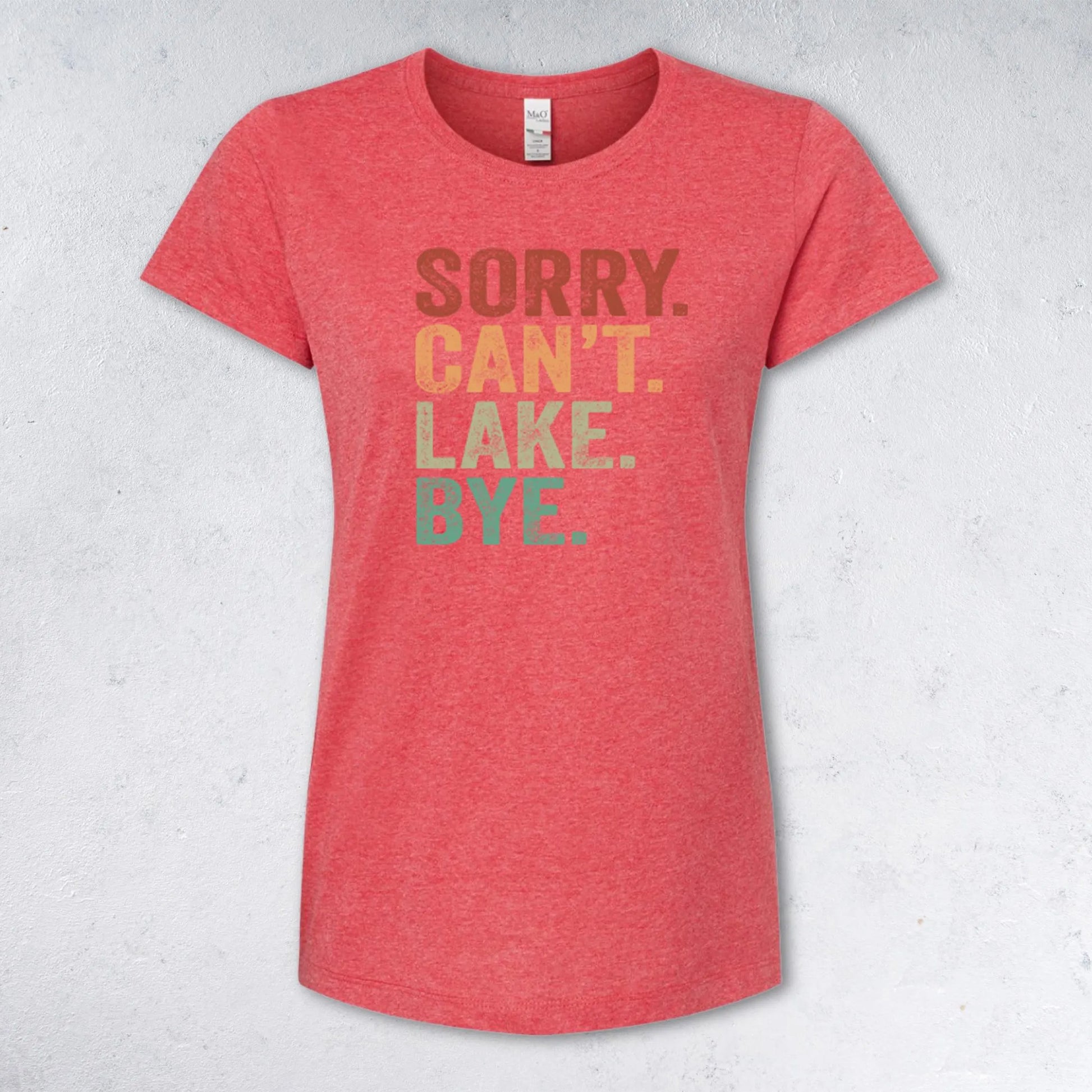 Red t-shirt with colorful text 'SORRY. CAN'T. LAKE. BYE.' on a light gray background