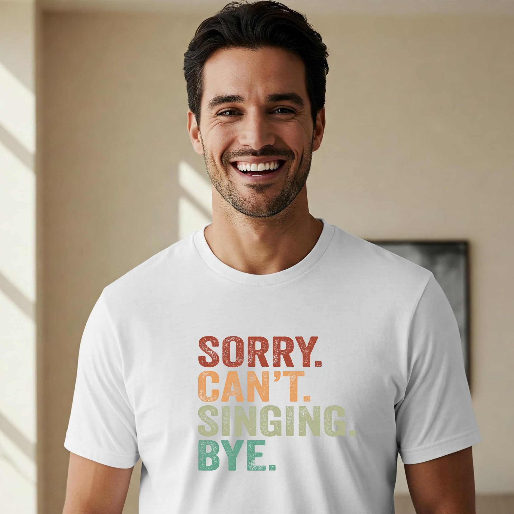 Man wearing a white t-shirt with colorful text in a room with a neutral background