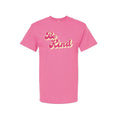 Pink t-shirt with 'Be Kind' text on a white background